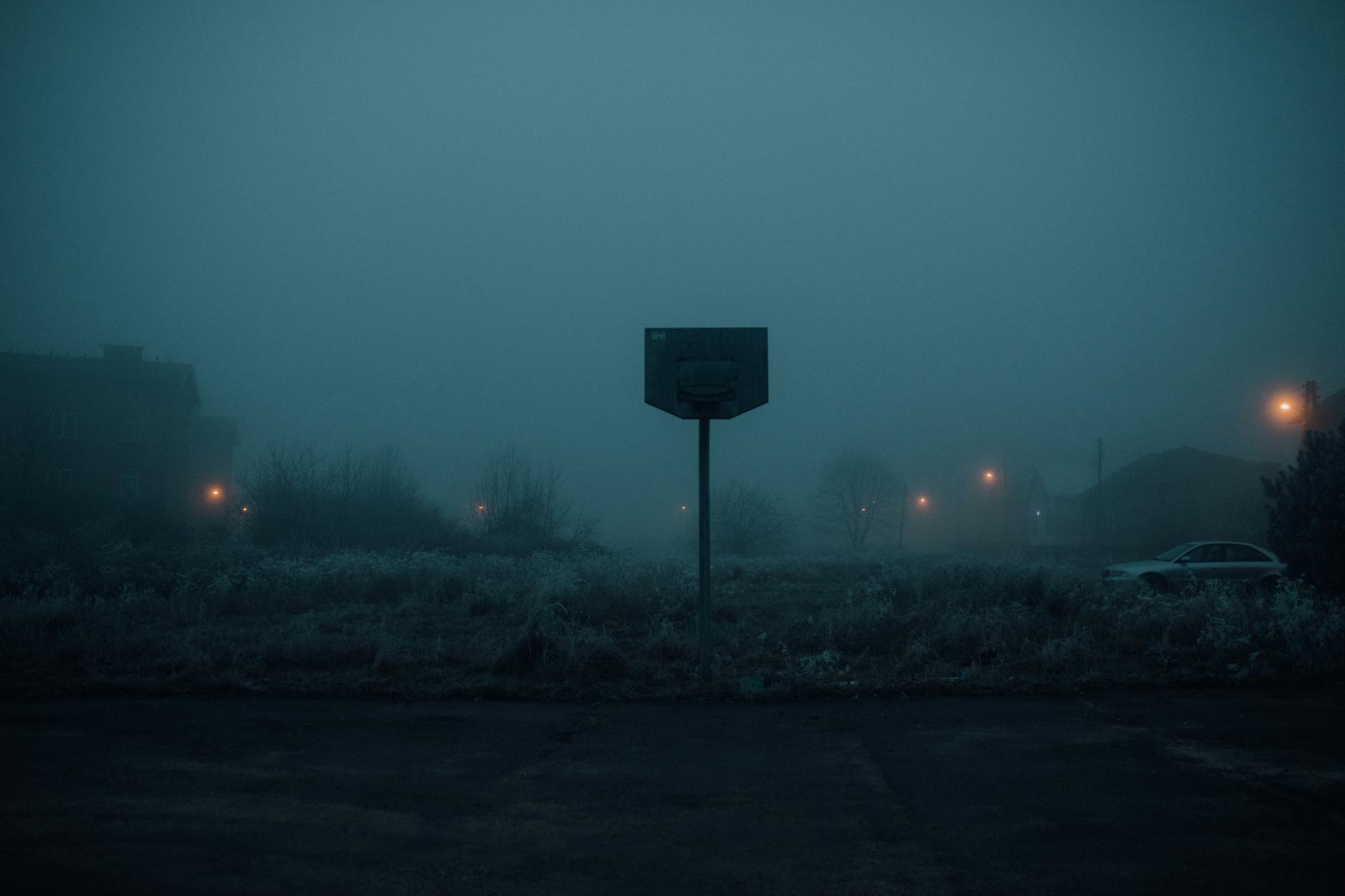 Basketball Court Near the Foggy Village
