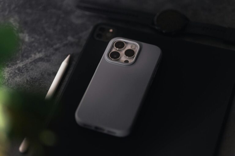 An iPhone and iPad Lying on a Gray Surface