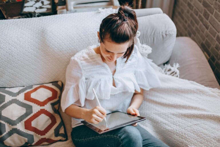 Woman Working on a Tablet in her Living Room