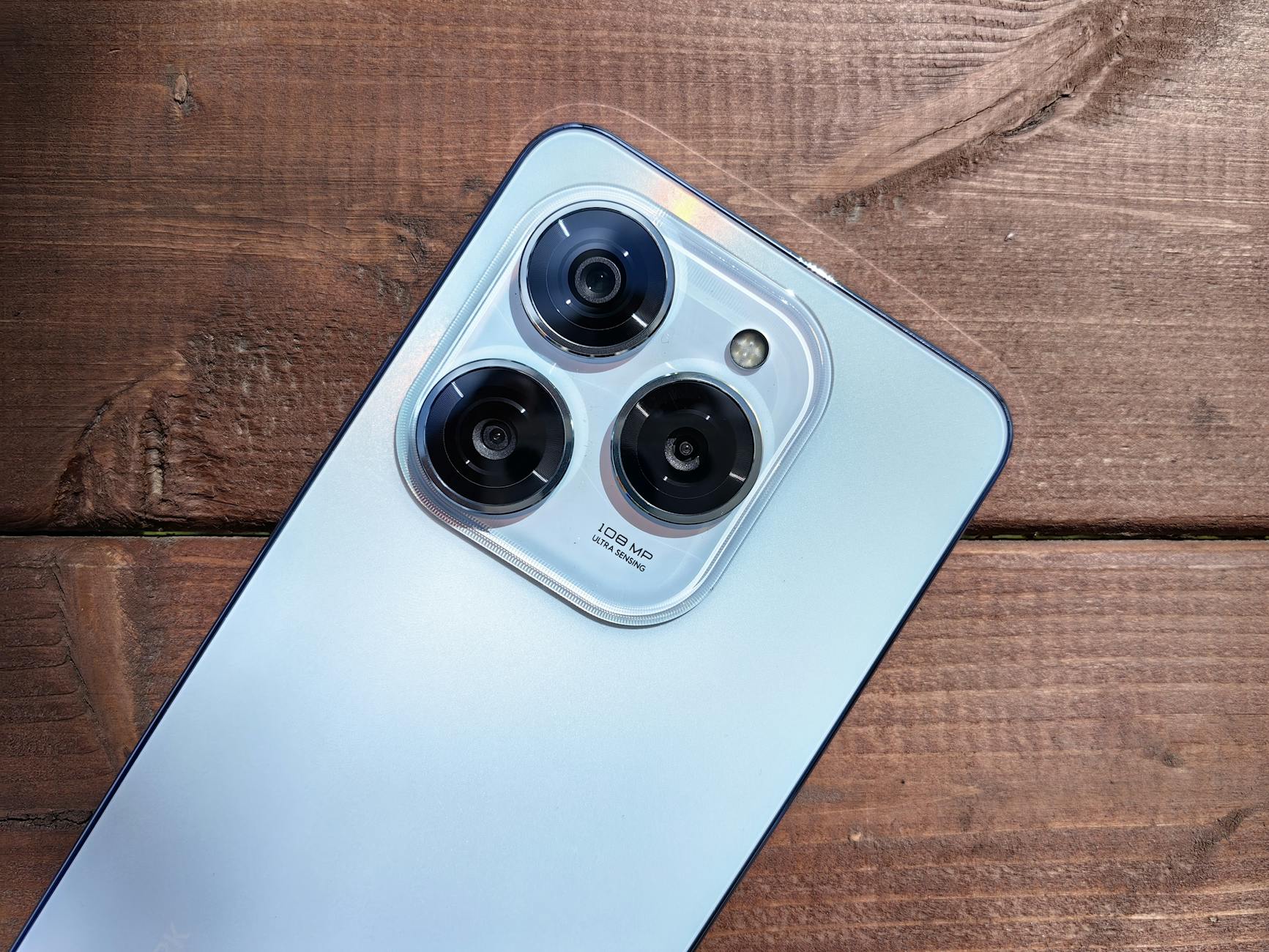 High-Resolution Smartphone Camera on Wooden Surface
